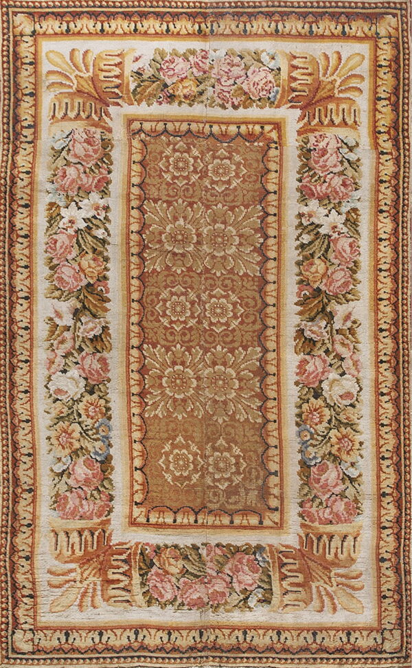 Rectangle rug showing a dense rust floral center framed by wide ivory panels with pink roses.