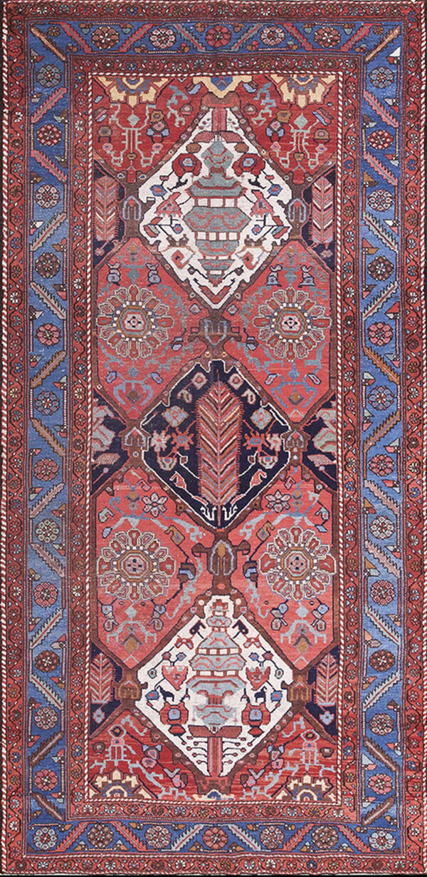 Red and navy tribal rug with a central row of three large diamond medallions and blue borders.