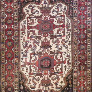 Ornate area rug featuring a central ivory medallion framed by red, black, and blue patterned borders.