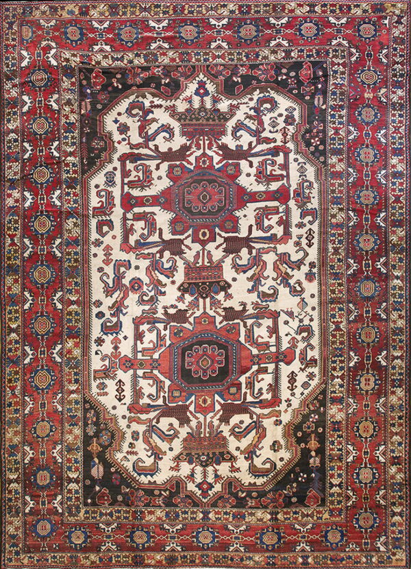 Ornate area rug featuring a central ivory medallion framed by red, black, and blue patterned borders.
