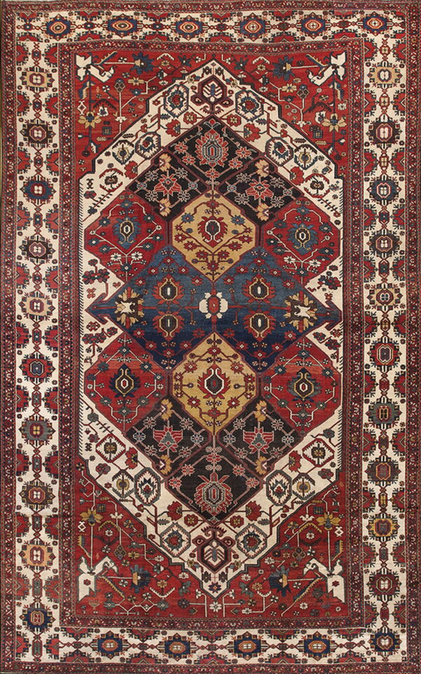 Intricate low-pile rug featuring a large central geometric pattern in red, blue, cream, and black.