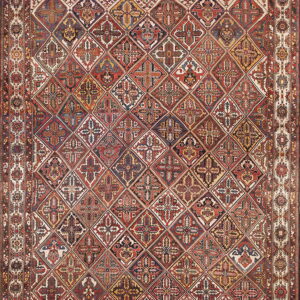 Red and navy rug with an intricate diagonal lattice pattern of multi-colored stylized floral diamonds.