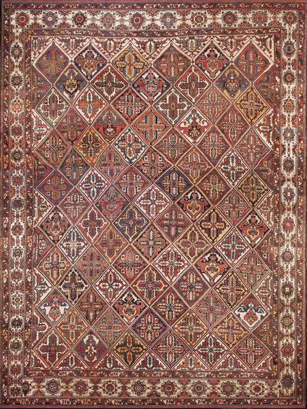 Red and navy rug with an intricate diagonal lattice pattern of multi-colored stylized floral diamonds.