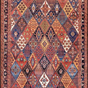 Intricate, multicolored rug displaying a grid of stylized geometric diamonds within a complex border.