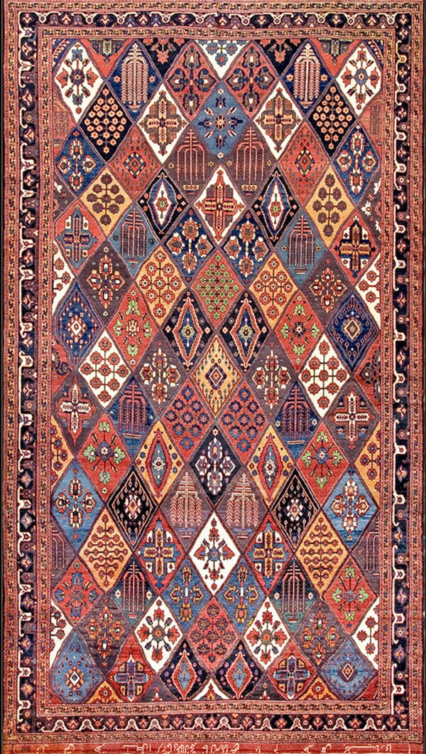 Intricate, multicolored rug displaying a grid of stylized geometric diamonds within a complex border.