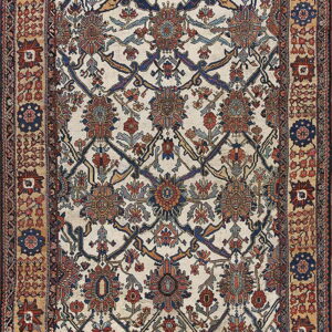 Ivory rug with complex blue and rust floral medallions and a wide, geometric tan border.