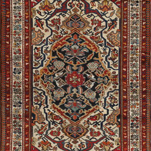 Long, colorful traditional rug displaying a complex dark center, geometric patterns, and multiple red and cream borders.