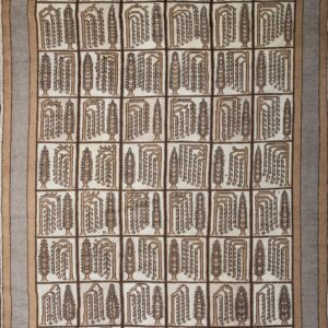 Cream rug featuring a geometric tiled pattern of brown abstract plant motifs and a layered gray border.