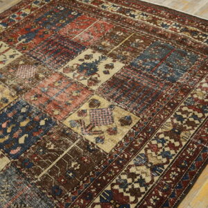 Diagonal pattern detail of a tightly woven rug in shades of cream, red, blue, and dark brown.