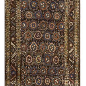 Narrow runner rug featuring a dark brown field filled with blue, rust, and gold geometric motifs.