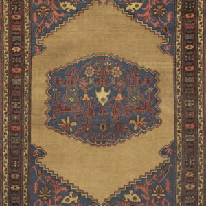 Traditional rug in gold and slate blue with rust accents, featuring a stepped medallion design.