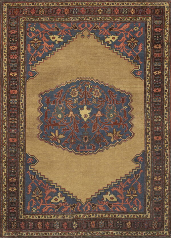 Traditional rug in gold and slate blue with rust accents, featuring a stepped medallion design.