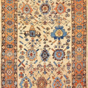 Traditional area rug with a beige field, featuring stylized blue and orange folk motifs and a wide orange border.