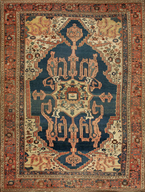 Traditional rug with a navy medallion, cream corners, and a multi-layered terracotta and blue geometric border.