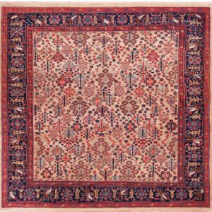 Beige patterned rug featuring stylized tree designs and a deep navy border with geometric bird motifs.