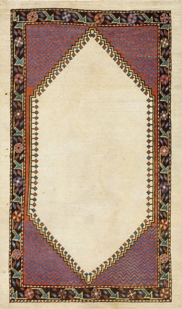 Low-pile rug with a cream center arch, detailed red and blue zig-zag panels, and a dark geometric floral border.