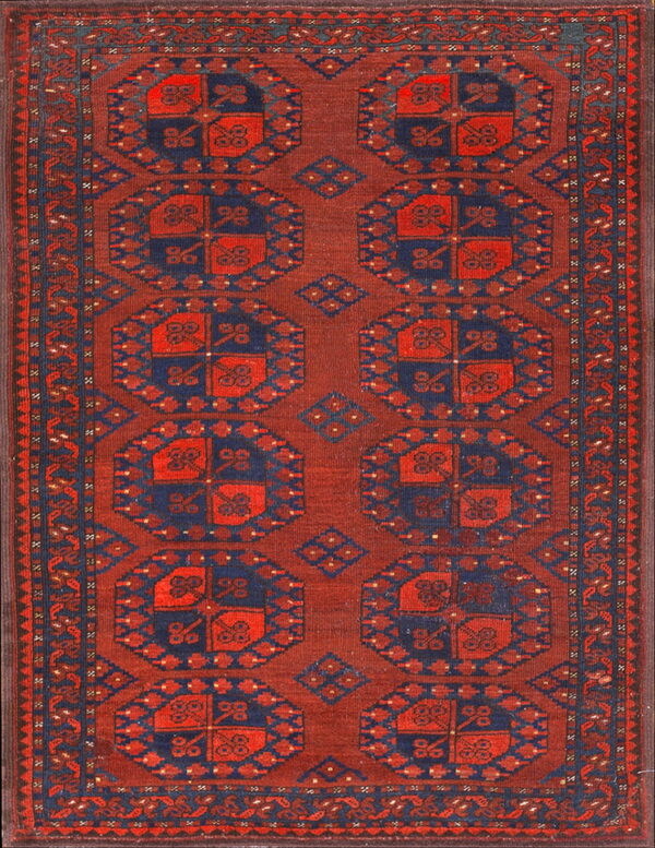 A deep red rug with large, repeating navy blue geometric medallions and elaborate borders.