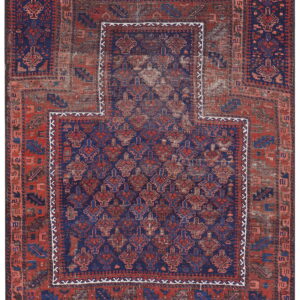 Geometric red and navy blue rug with visible wear and a large, stepped central panel outline.