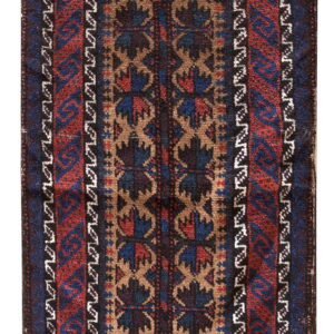 High pile rug displaying traditional patterns in deep red, navy blue, and tan against a dark background.