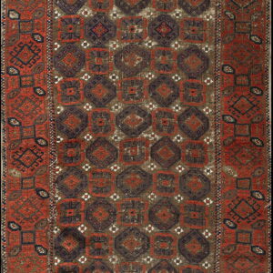 Rust-red and dark brown rug featuring repetitive geometric octagonal and square medallions in a traditional pattern.