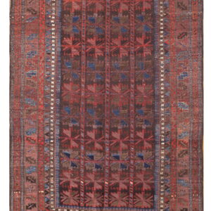 Dark, traditional geometric rug featuring repeating red and blue motifs on a deep brown field.