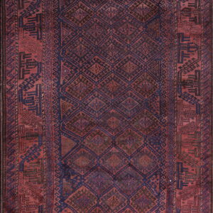 Geometric rug in rich reds and indigo blue features a center diamond lattice and stylized borders.