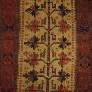 Tan rug with a central Tree of Life motif and stylized animal figures framed by a reddish-brown geometric border.
