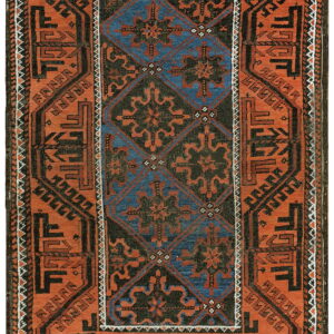 Geometric rug in rust orange, dark brown, and blue with a detailed central diamond pattern.