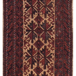 Red and brown geometric rug featuring a thick central column of repeating tribal motifs on a tan background.
