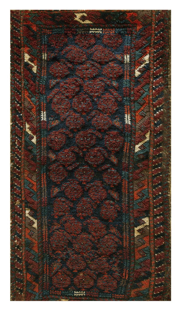 Textured runner with dark red circular motifs over an indigo field and rust, teal, and beige borders.