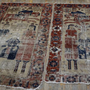 Low-pile rug with faded red and blue pictorial designs on a distressed tan ground over wood flooring.