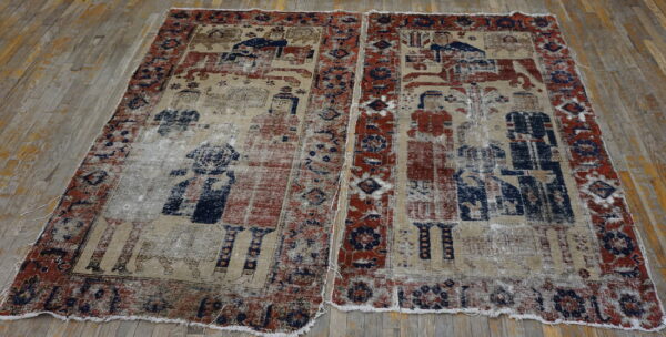Low-pile rug with faded red and blue pictorial designs on a distressed tan ground over wood flooring.