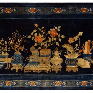 A deep blue rug features vases, flowers, and objects in gold and orange, bordered by blue fretwork.