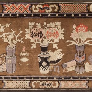 Decorative brown rug depicting pink and cream flowers in vases alongside books and scrolls within a complex border.