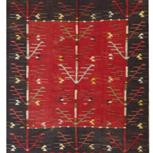 Flatwoven rug in red, black, and olive green with repeating geometric tree and medallion motifs.
