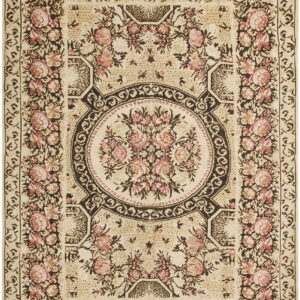 Cream rug with pink floral motifs and dark brown scrolling borders surrounding a central bouquet.