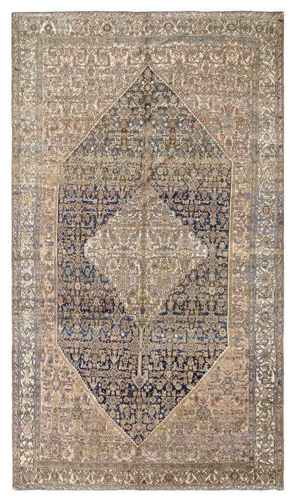 Rectangular rug with an intricate central navy diamond medallion and a cream and pink field.