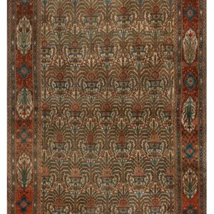 The rug features a repeating stylized tree pattern in brown and blue with an elaborate terracotta border.