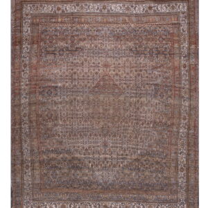 A distressed traditional rug with a central medallion in faded browns, tans, and muted blue tones.