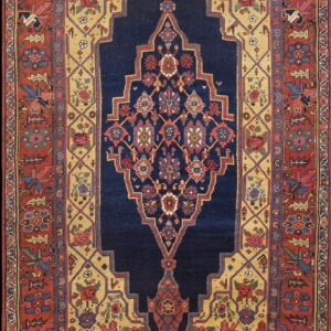 High-pile rug with a navy medallion, gold field, and stepped rust border featuring complex floral patterns.