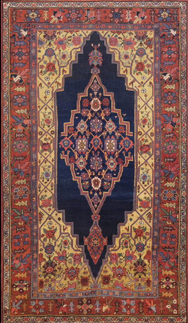 High-pile rug with a navy medallion, gold field, and stepped rust border featuring complex floral patterns.