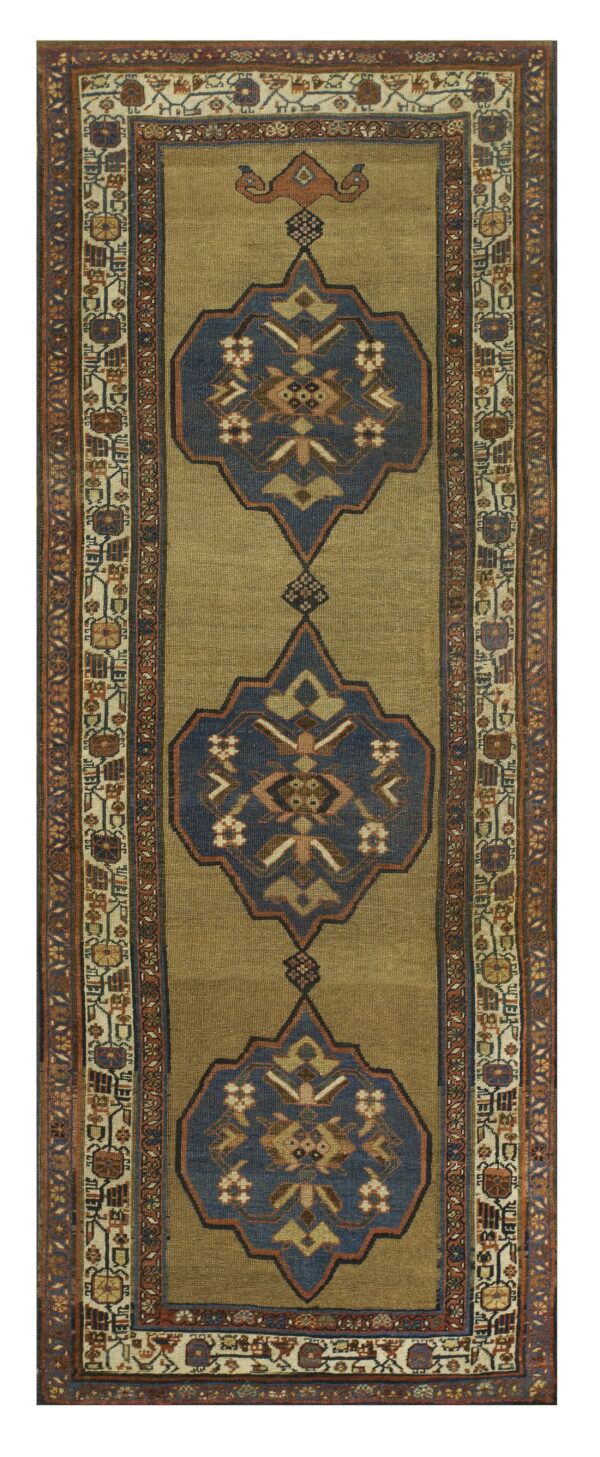 Long runner rug featuring an olive green field with three large navy and rust geometric medallions.