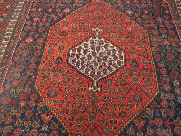Intricate red and blue patterned rug