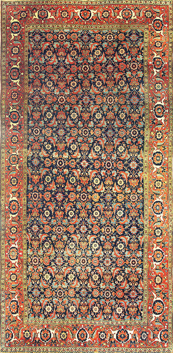 A colorful rug with a deep navy field, dense floral pattern in orange and teal, and a wide primary red border.