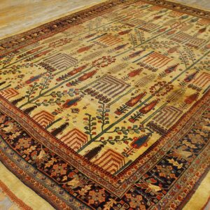Golden yellow rug featuring a repeating stylized tree pattern bordered by dark navy animal and floral motifs.