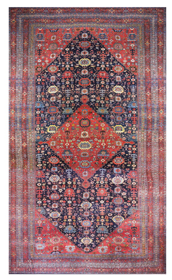 Red and dark blue traditional rug featuring a detailed central medallion and wide patterned borders.