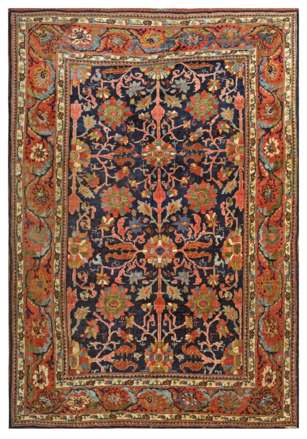 Detailed, medium-pile rug featuring red and green ornate florals on a navy-blue central field and rust borders.