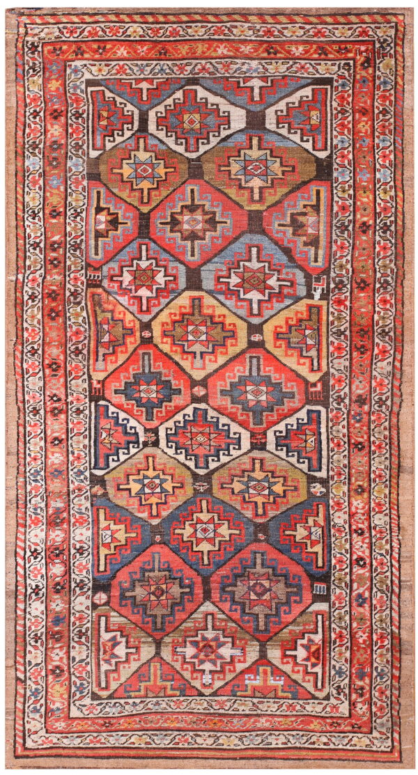 Red, blue, and tan geometric rug featuring a vertical arrangement of large diamond medallions.