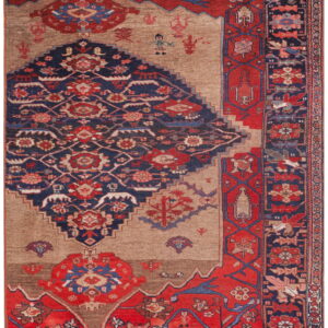 Ornate patterned rug featuring a large stepped navy and red medallion against a rustic brown and tan field.