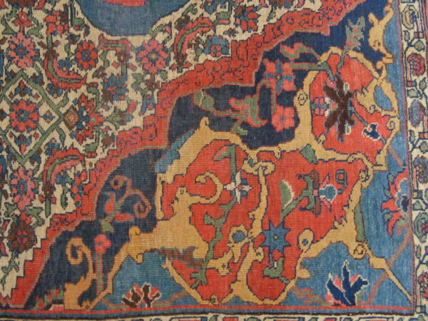 Detailed view of a low-pile rug featuring red, dark blue, beige, and yellow stylized animals and flowers.